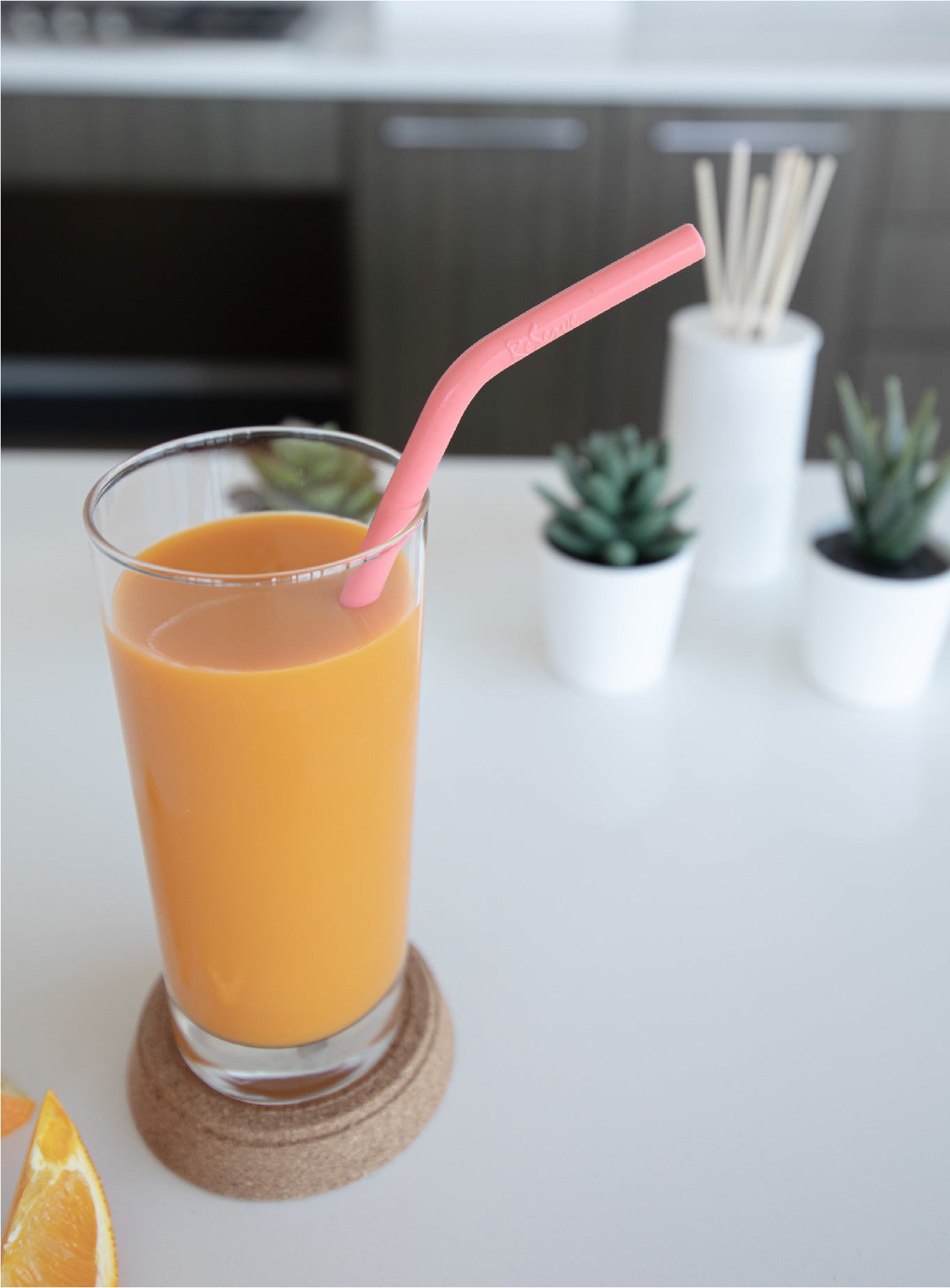 Pink Living Coral Duo-hardness Silicone Straw in a glass of orange juice